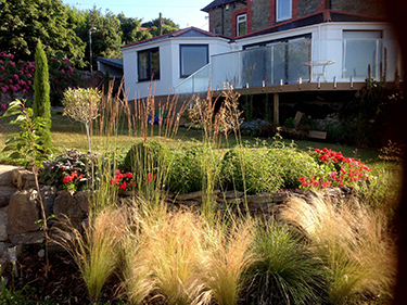 Soft grasses coastal sloping garden sunny day